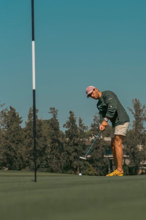 Golfer putting on a sunny green — returning to an active life after spine care